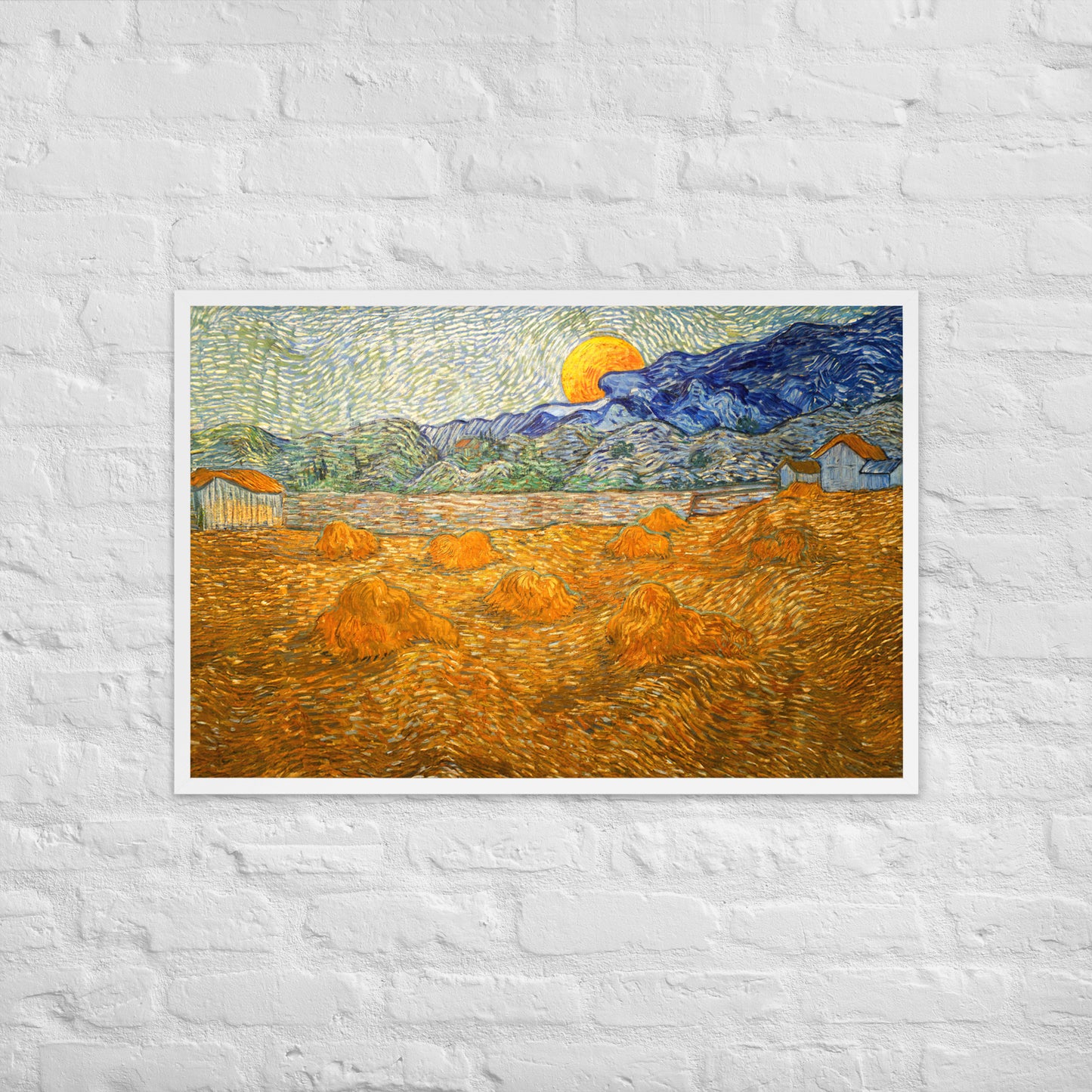 Van Gogh's 'Landscape with Wheat Sheaves and Rising Moon' on a 24"x36" white framed poster print on a white brick wall.