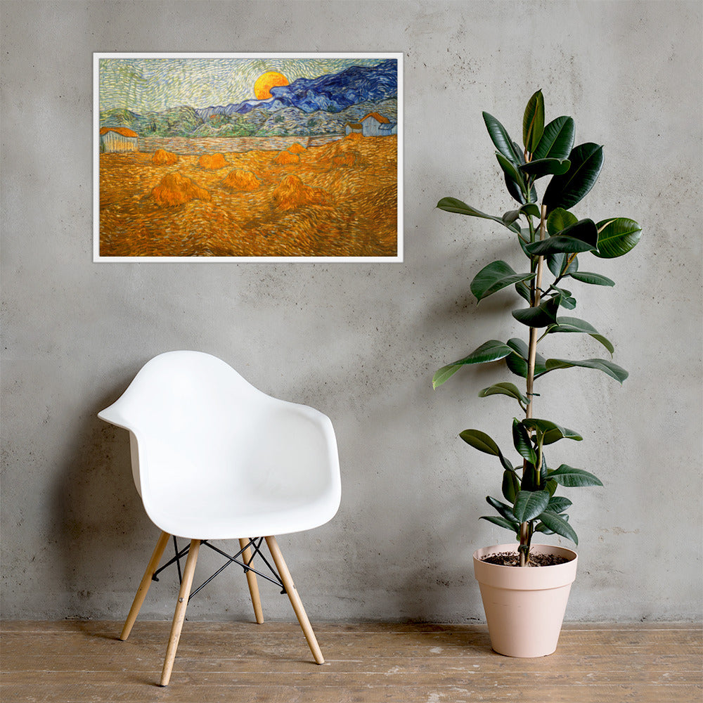 Van Gogh's 'Landscape with Wheat Sheaves and Rising Moon' on a 24"x36" white framed poster print on a light gray concrete wall with a white chair and plant below.