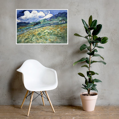 Van Gogh's 'Landscape from Saint-Rémy' on a 24"x36" white framed poster print on a light gray concrete wall with a white chair and plant below.