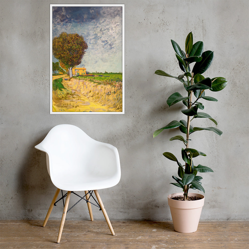 Van Gogh's 'A Lane near Arles' on a 24"x36" white framed poster print on a light gray concrete wall with a white chair and plant below.