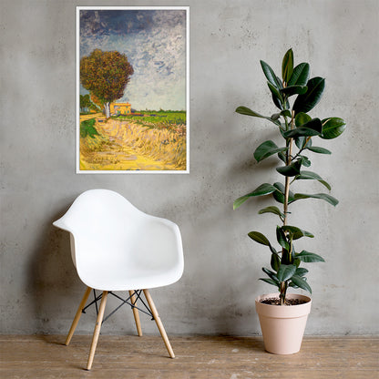 Van Gogh's 'A Lane near Arles' on a 24"x36" white framed poster print on a light gray concrete wall with a white chair and plant below.