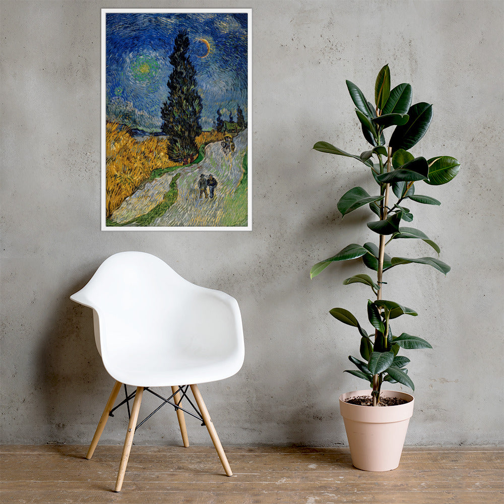 Van Gogh's 'Road with Cypress and Star' on a 24"x36" white framed poster print on a light gray concrete wall with a white chair and plant below.