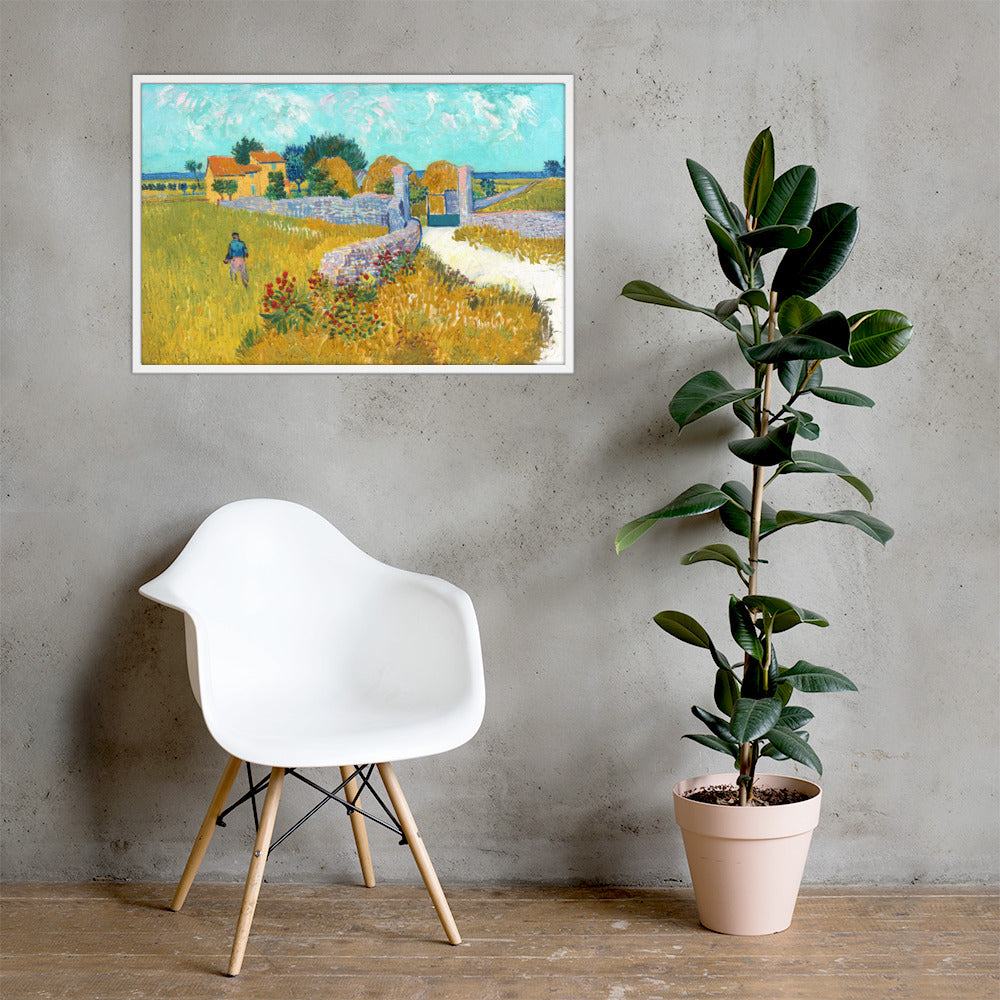Van Gogh's 'Farmhouse in Provence' on a 24"x36" white framed poster print on a light gray concrete wall with a white chair and plant below.
