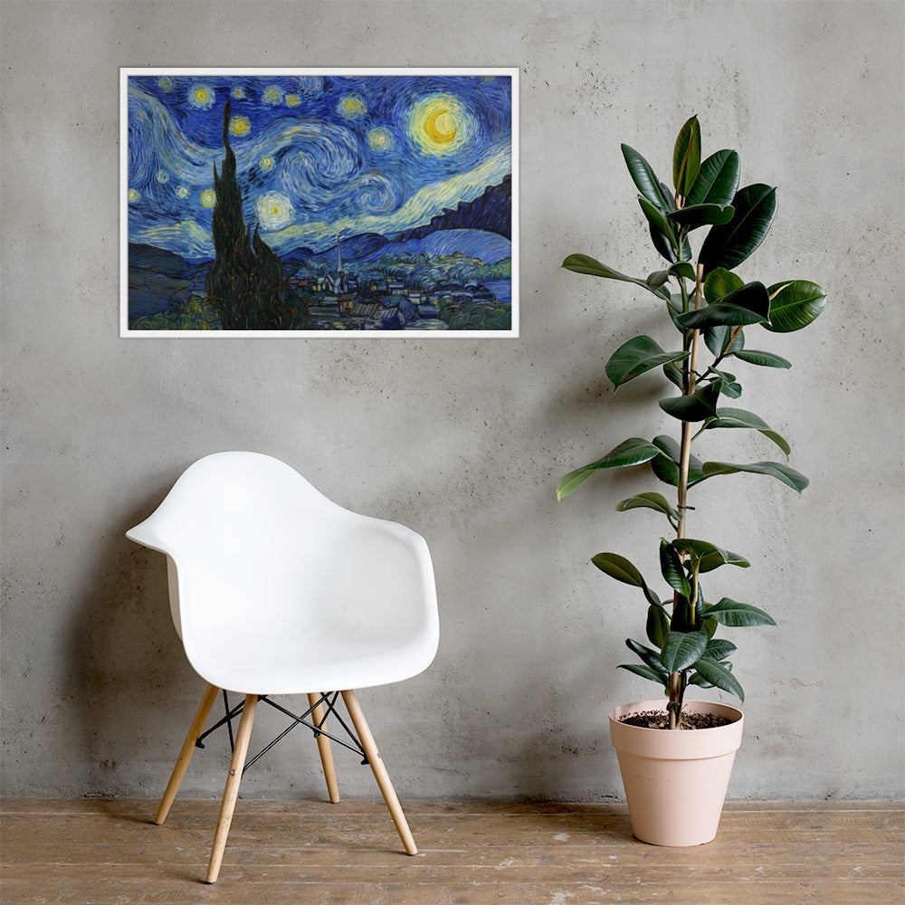 Van Gogh's 'Starry Night' on a 24"x36" white framed poster print on a light gray concrete wall with a white chair and plant below.