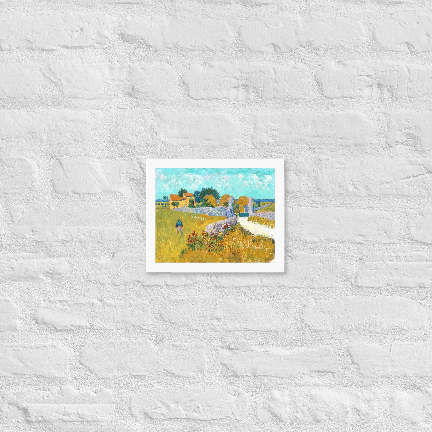 Van Gogh's 'Farmhouse in Provence' on a 8"x10" white framed poster print on a white brick wall.