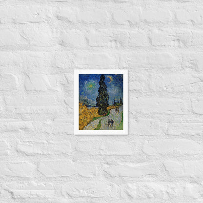 Van Gogh's 'Road with Cypress and Star' on a 8"x10" white framed poster print on a white brick wall.