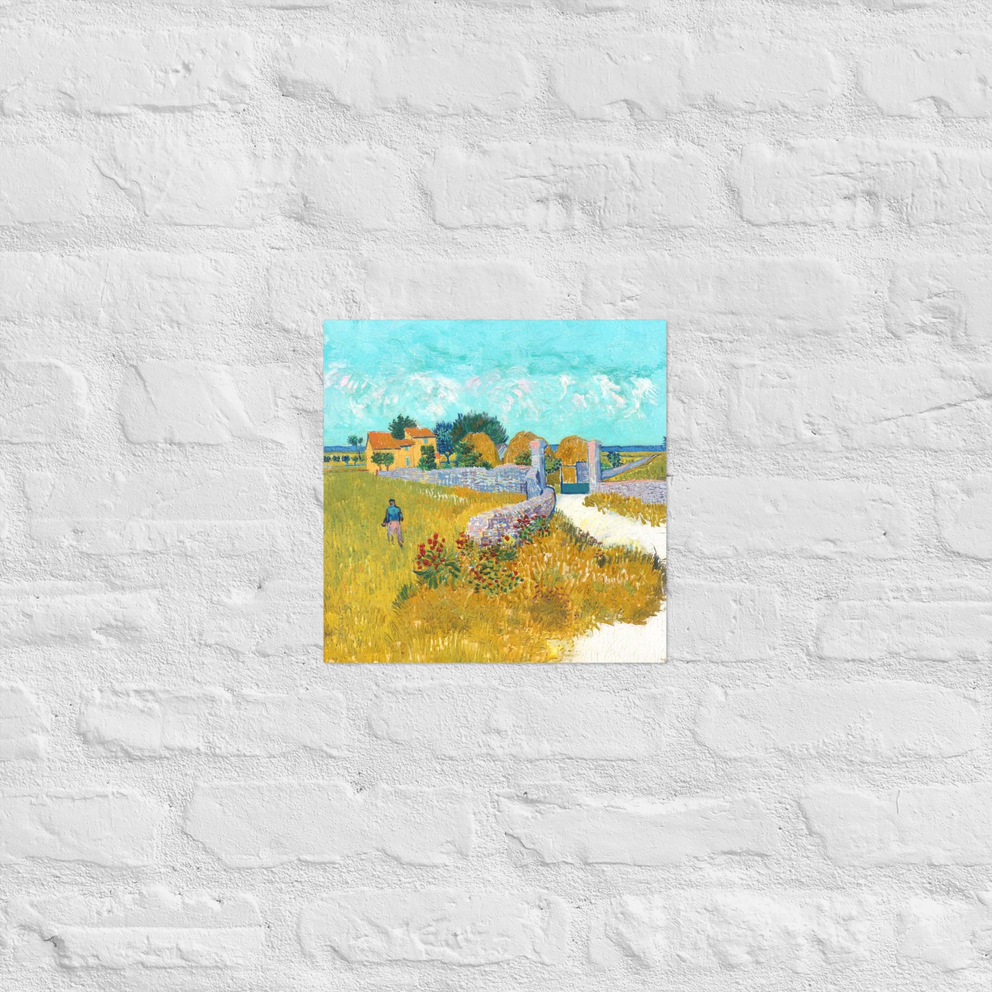 Van Gogh's 'Farmhouse in Provence' on a 12"x12" unframed poster print on a white brick wall.