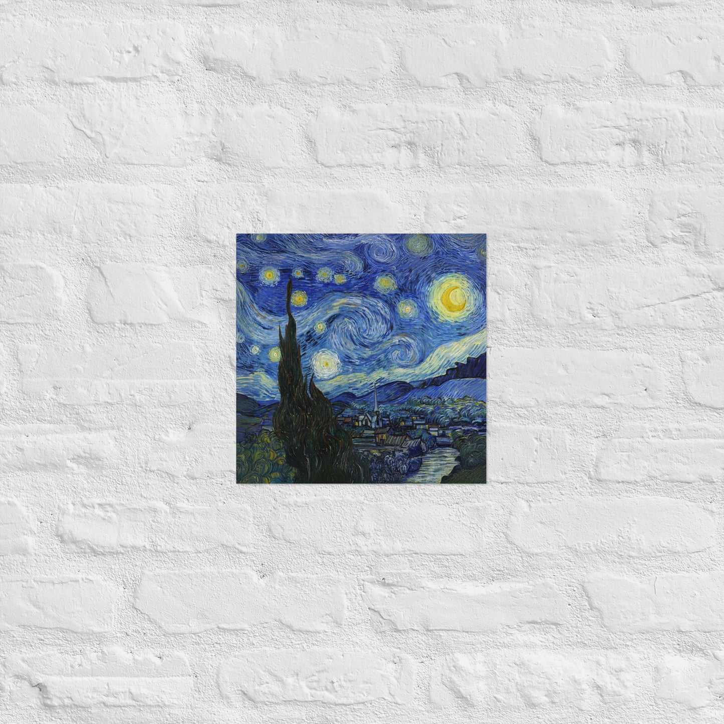 Van Gogh's 'Starry Night' on a 12"x12" unframed poster print on a white brick wall.