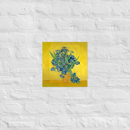 Van Gogh's 'Vase with Irises Against a Yellow Background' on a 12"x12" unframed poster print on a white brick wall.