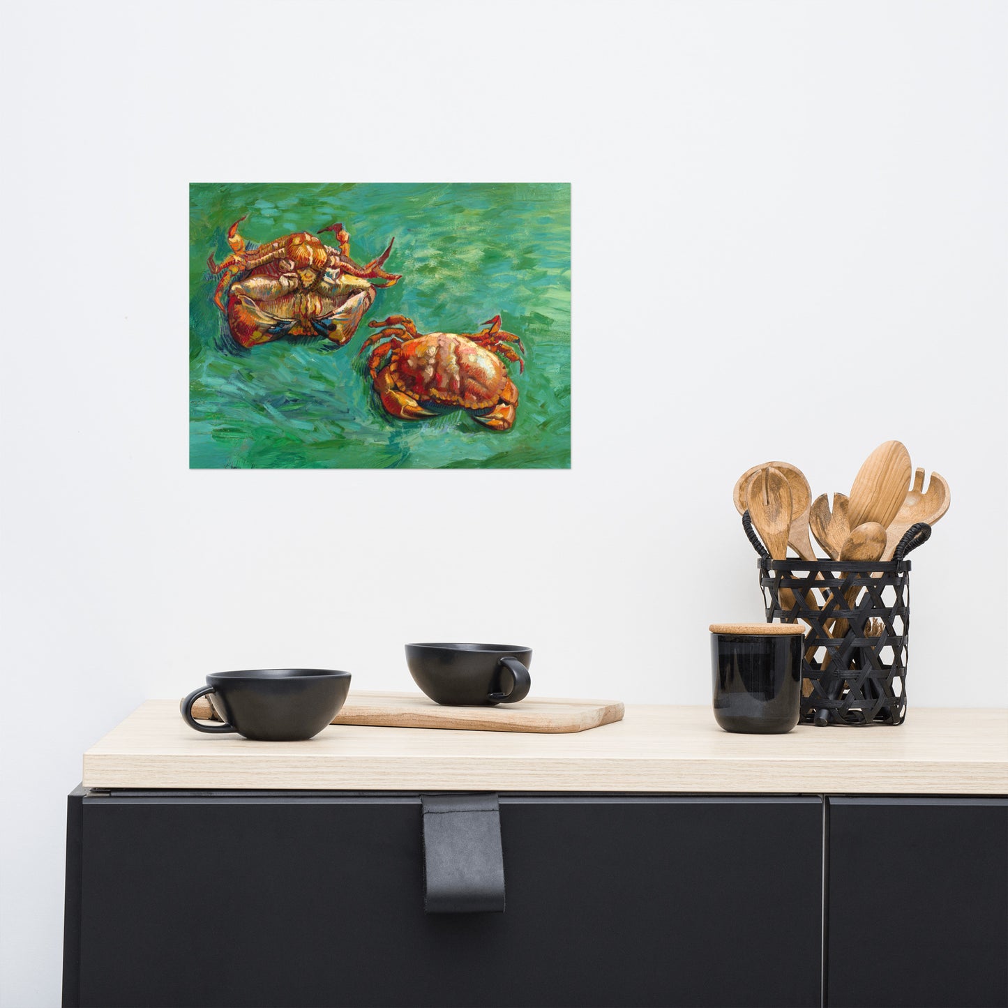 Van Gogh's 'Two Crabs' on a 12"x16" unframed poster print on a white wall above a kitchen counter with cooking supplies.