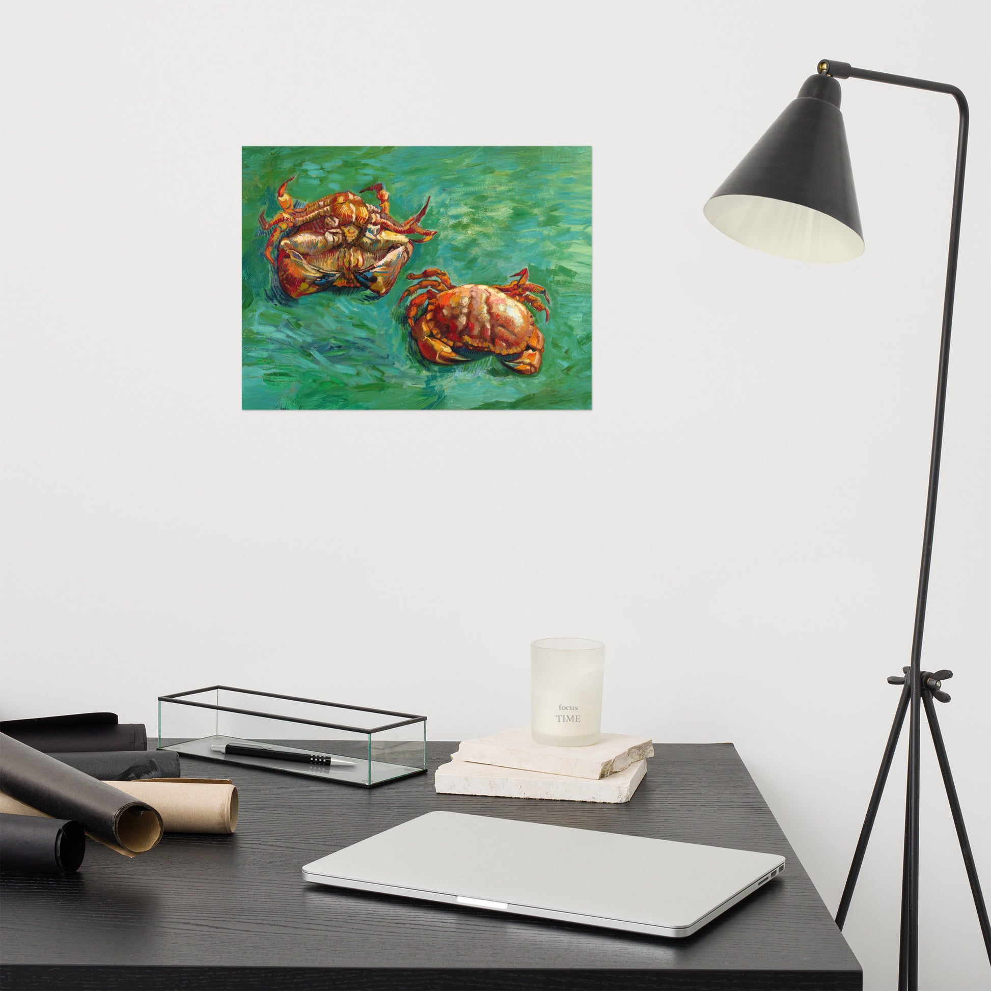 Van Gogh's 'Two Crabs' on a 12"x16" unframed poster print on a white wall above a modern office desk, lamp, and assorted desk items.