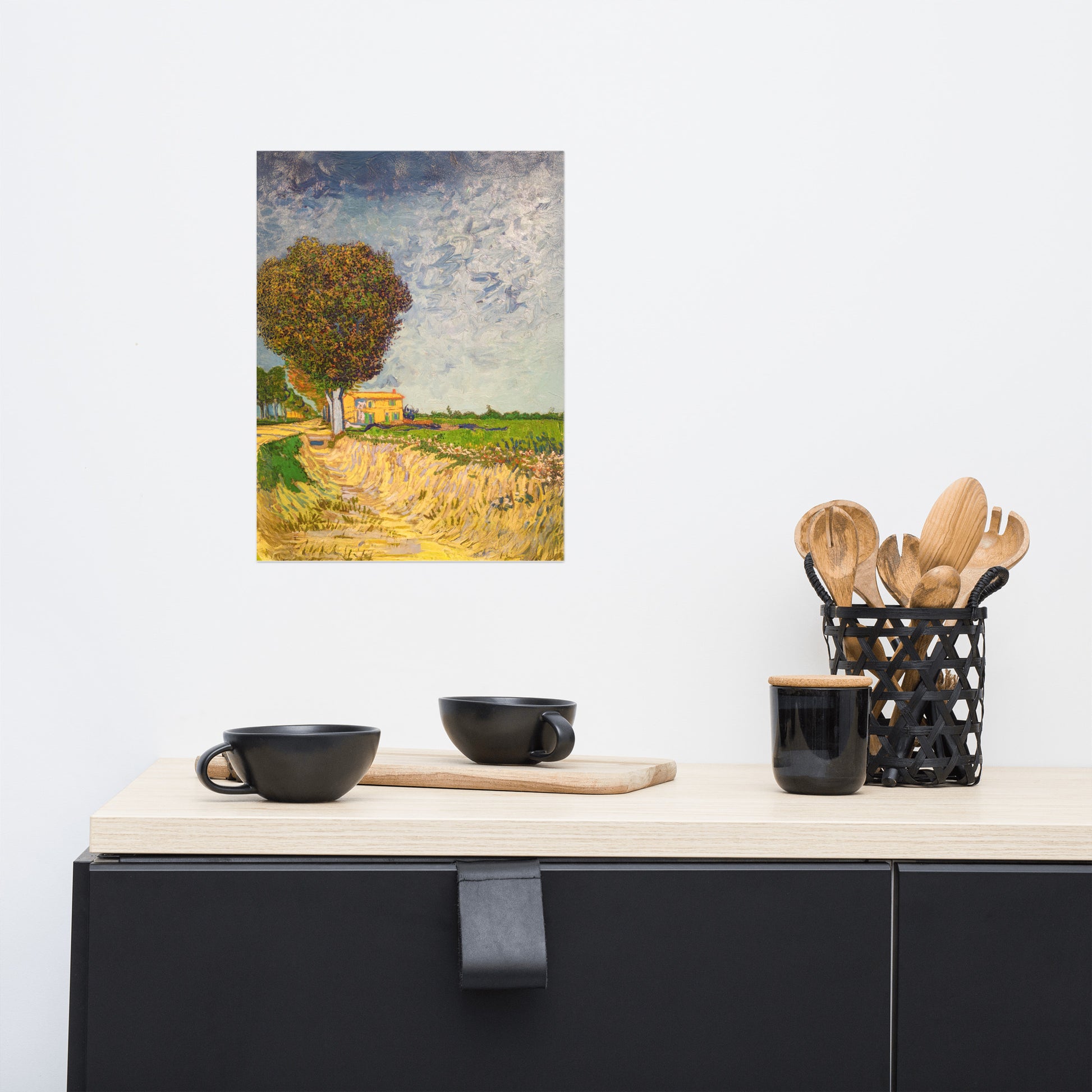 Van Gogh's 'A Lane near Arles' on a 12"x16" unframed poster print on a white wall above a kitchen counter with cooking supplies.