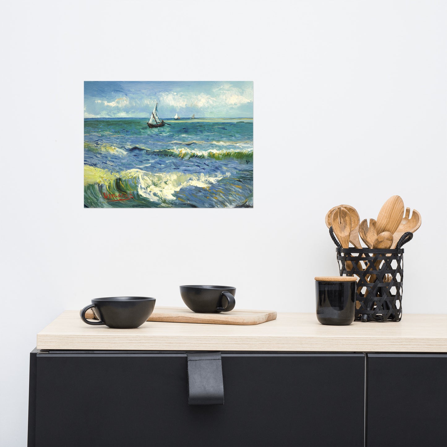 Van Gogh's 'The Sea at Les Saintes-Maries-de-la-Mer' on a 12"x16" unframed poster print on a white wall above a kitchen counter with cooking supplies.