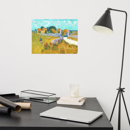 Van Gogh's 'Farmhouse in Provence' on a 12"x16" unframed poster print on a white wall above a modern office desk, lamp, and assorted desk items.