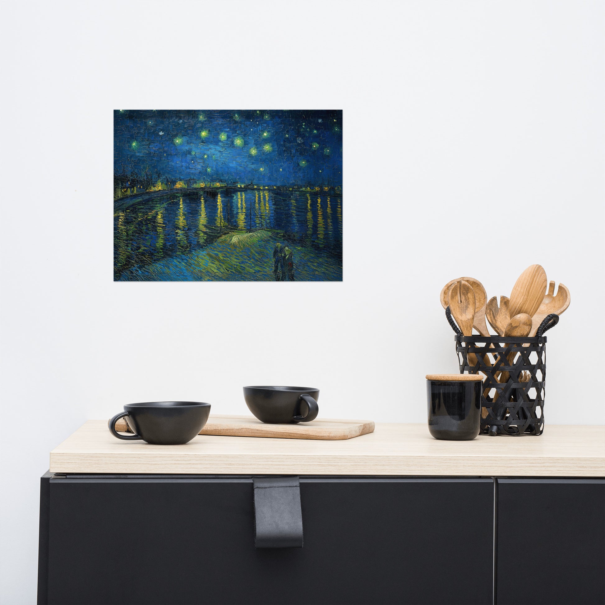 Van Gogh's 'Starry Night Over the Rhone' on a 12"x16" unframed poster print on a white wall above a kitchen counter with cooking supplies.