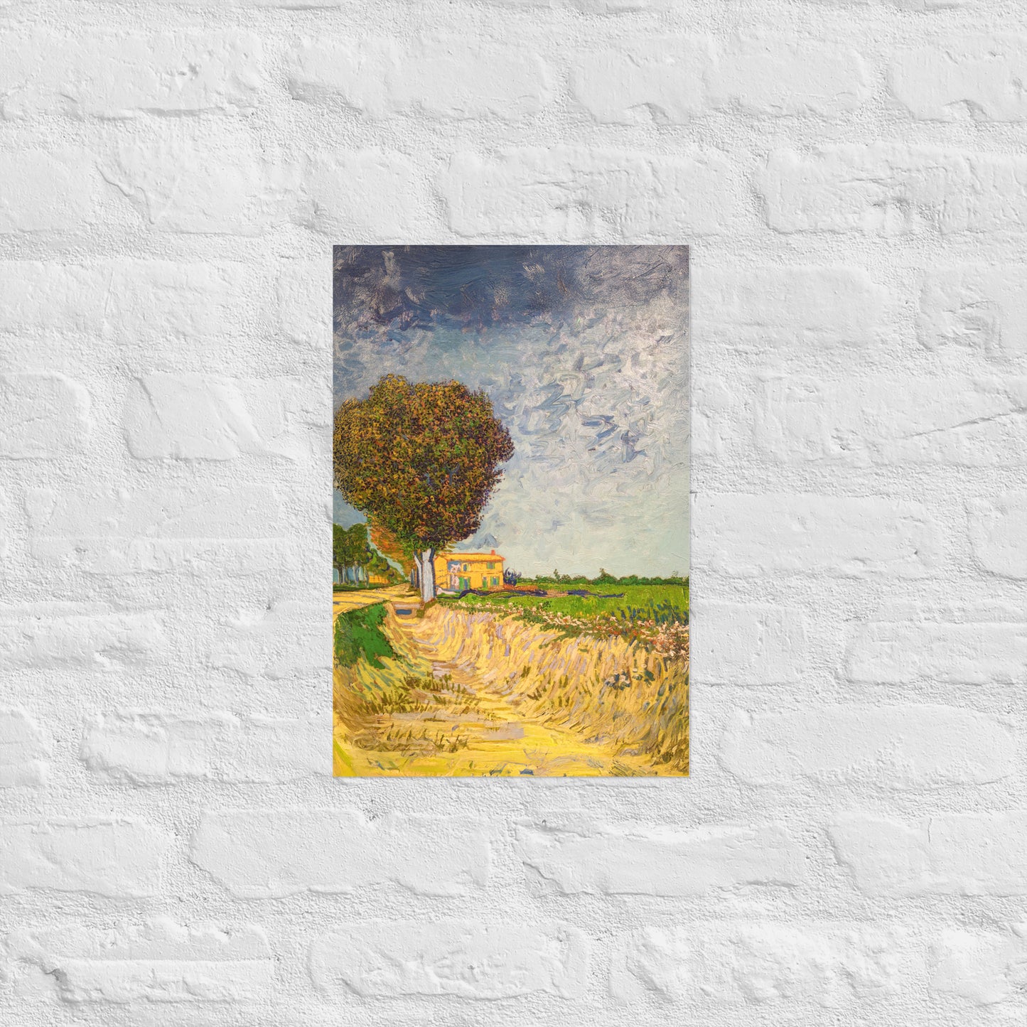 Van Gogh's 'A Lane near Arles' on a 12"x18" unframed poster print on a white brick wall.