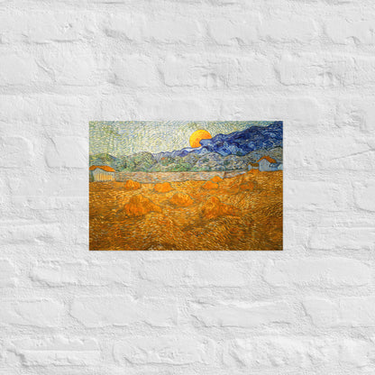 Van Gogh's 'Landscape with Wheat Sheaves and Rising Moon' on a 12"x18" unframed poster print on a white brick wall.