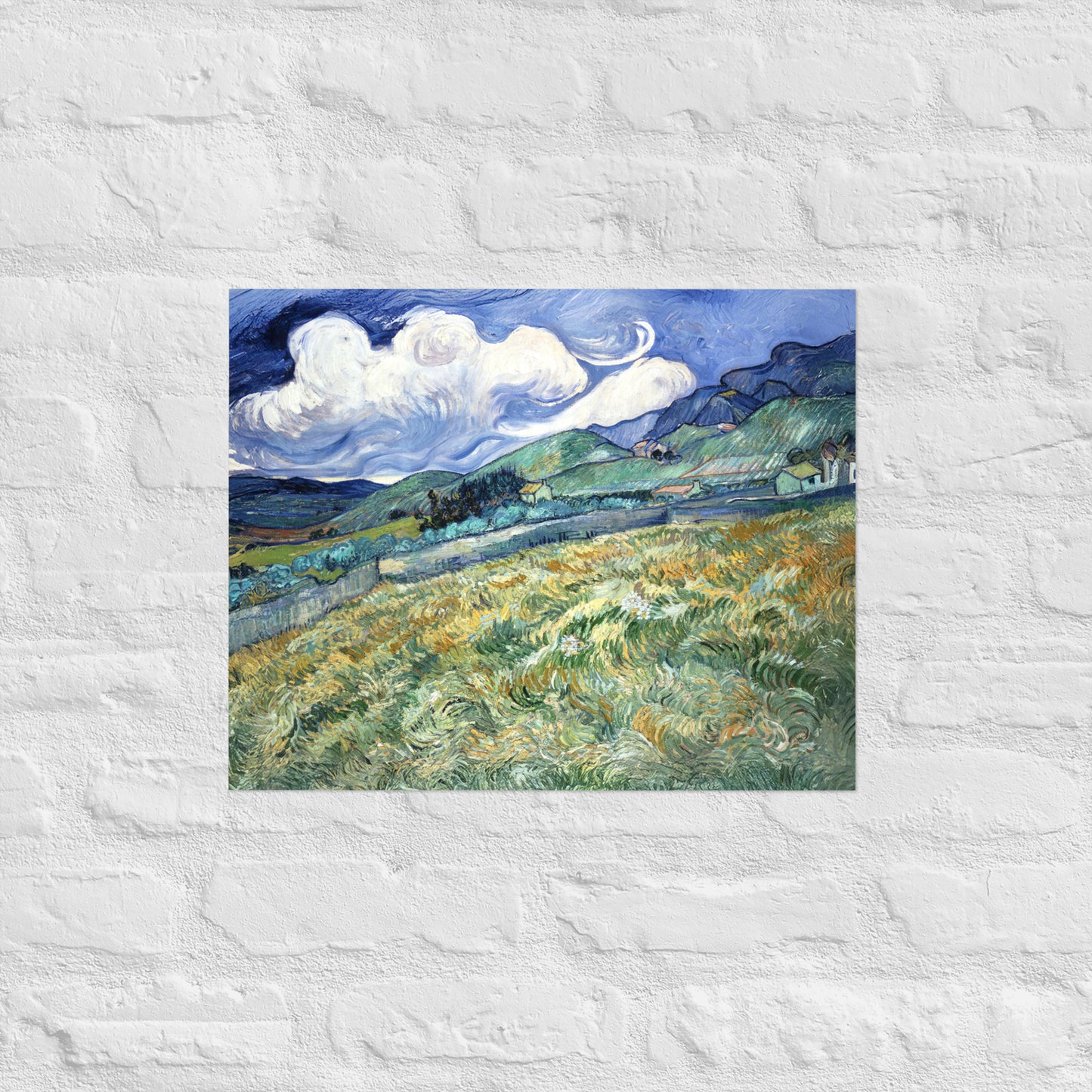 Van Gogh's 'Landscape from Saint-Rémy' on a 16"x20" unframed poster print on a white brick wall.