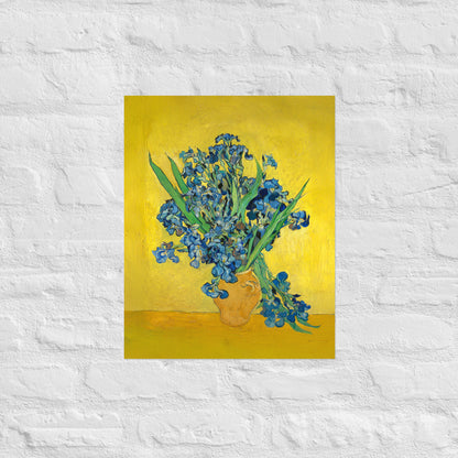 Van Gogh's 'Vase with Irises Against a Yellow Background' on a 16"x20" unframed poster print on a white brick wall.