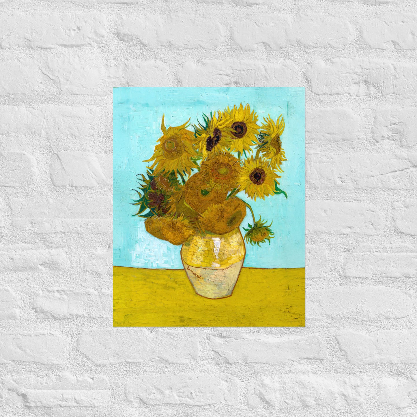 Van Gogh's 'Vase with Twelve Sunflowers' on a 16"x20" unframed poster print on a white brick wall.