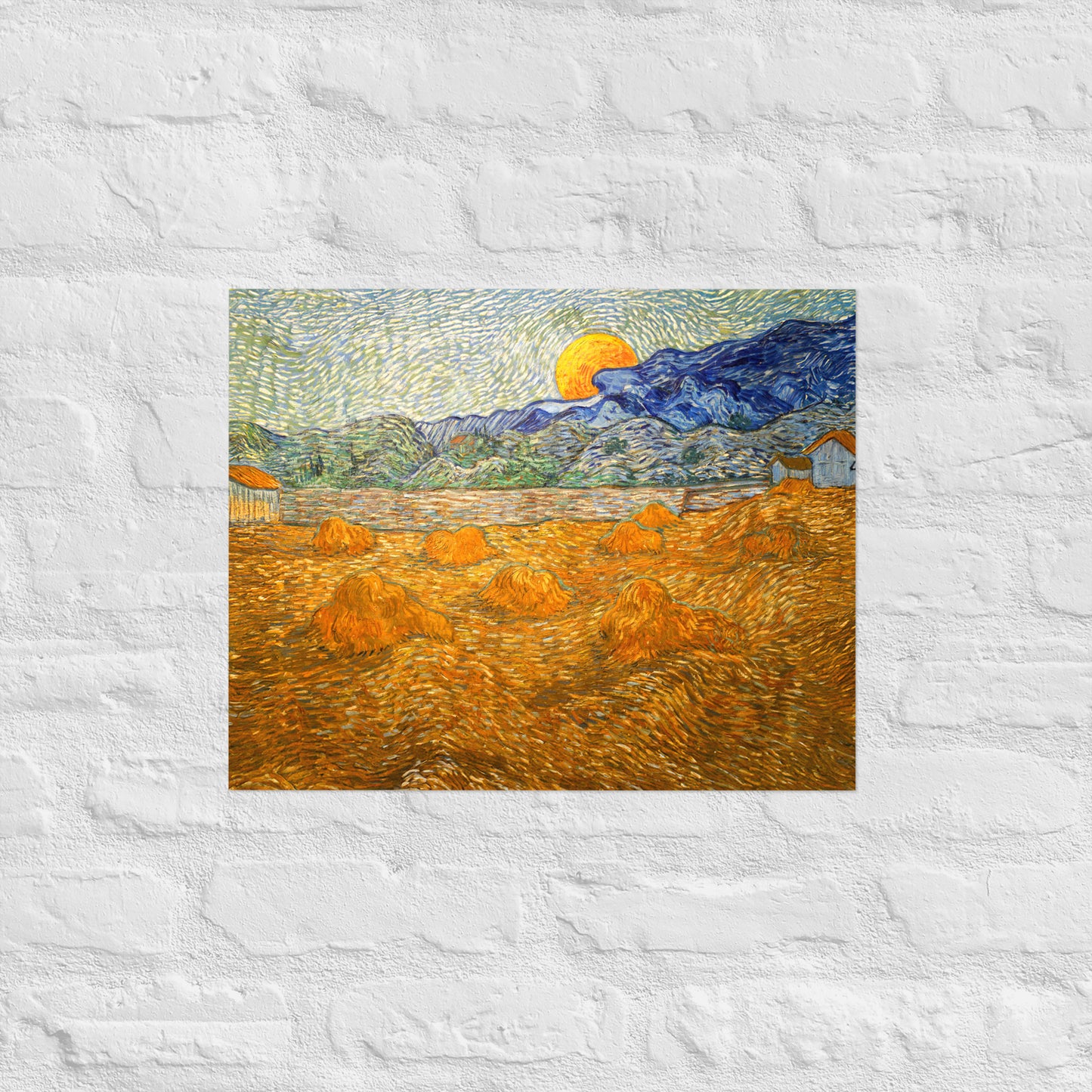 Van Gogh's 'Landscape with Wheat Sheaves and Rising Moon' on a 16"x20" unframed poster print on a white brick wall.