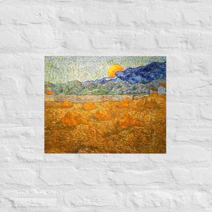 Van Gogh's 'Landscape with Wheat Sheaves and Rising Moon' on a 16"x20" unframed poster print on a white brick wall.