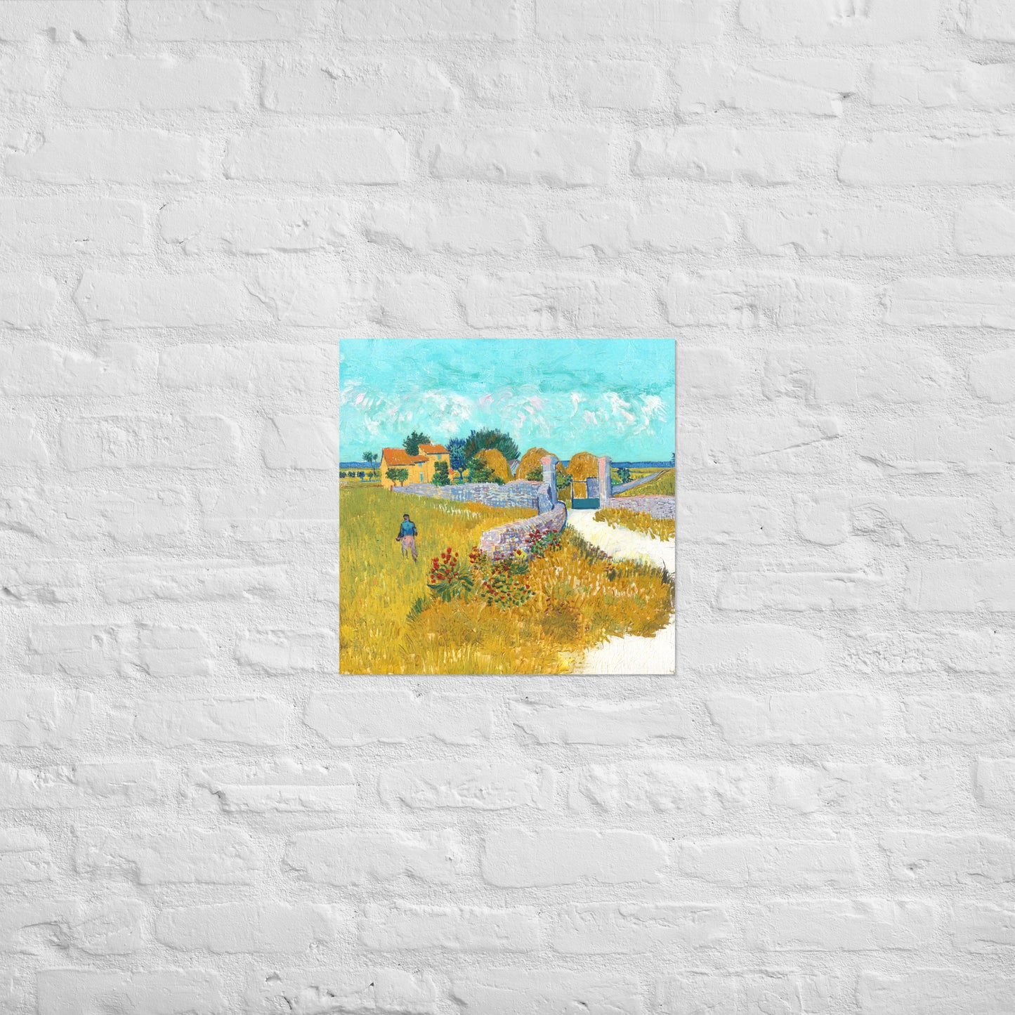 Van Gogh's 'Farmhouse in Provence' on a 18"x18" unframed poster print on a white brick wall.