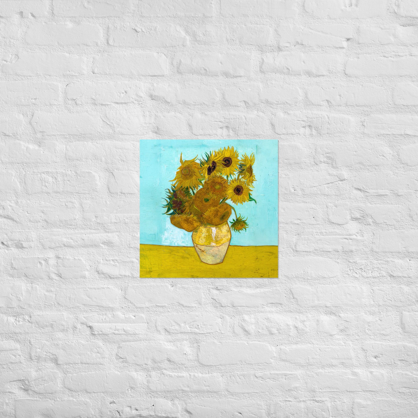 Van Gogh's 'Vase with Twelve Sunflowers' on a 18"x18" unframed poster print on a white brick wall.