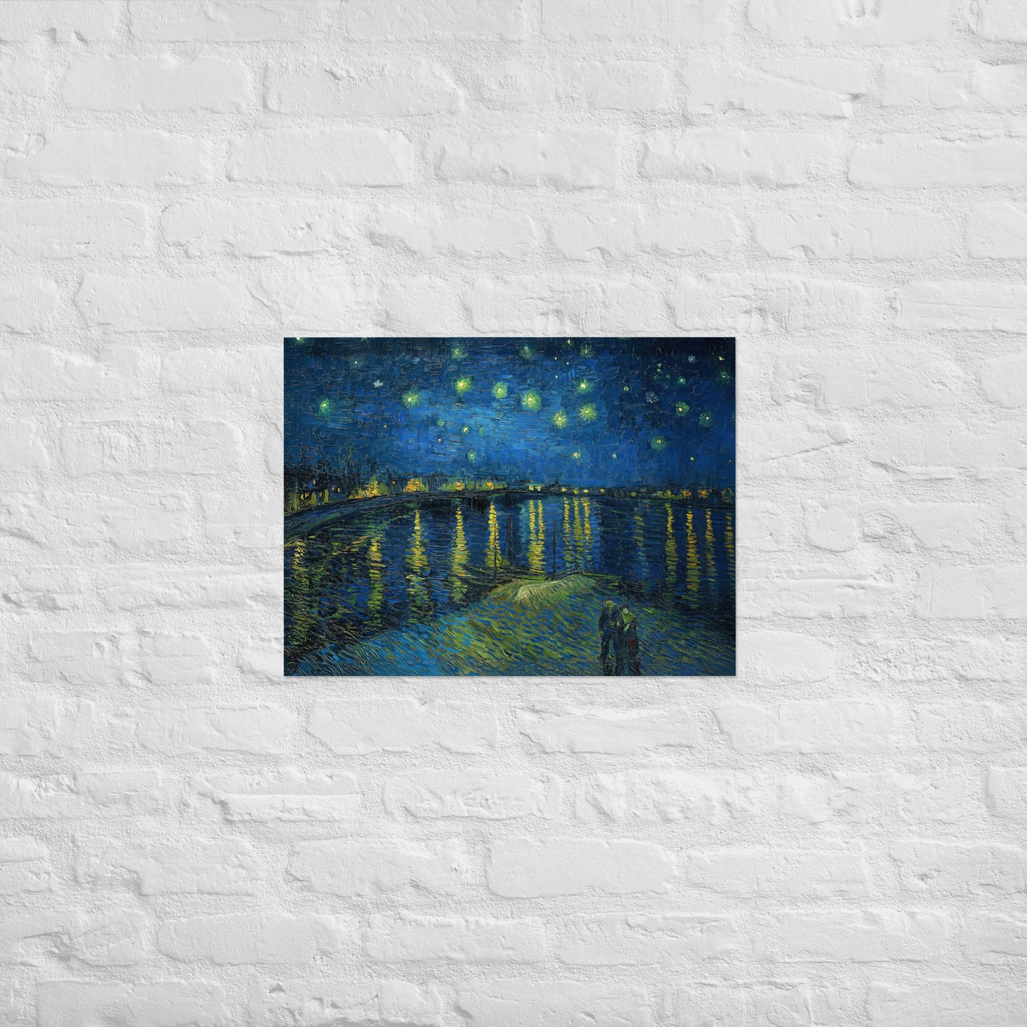 Van Gogh's 'Starry Night Over the Rhone' on a 18"x24" unframed poster print on a white brick wall.