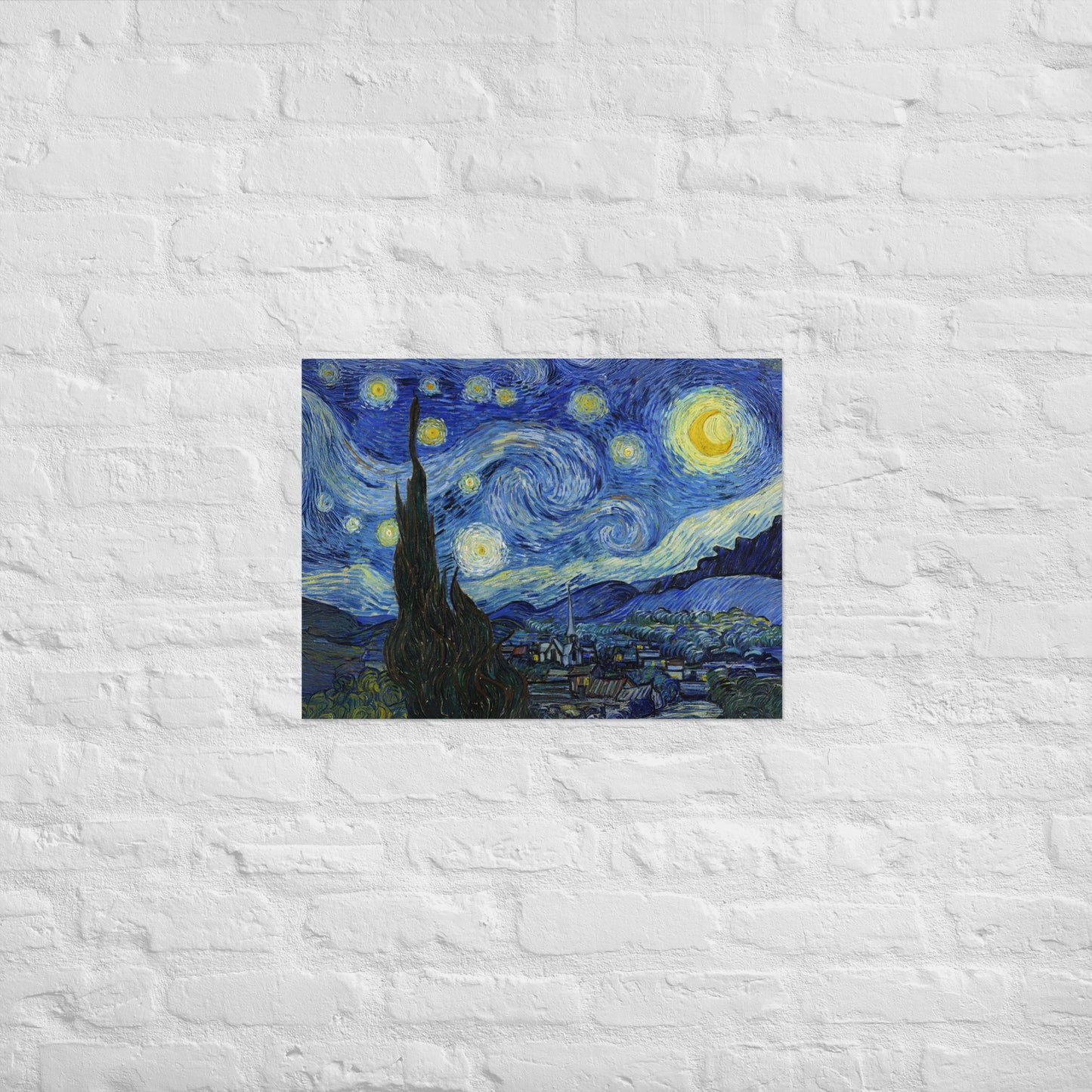 Van Gogh's 'Starry Night' on a 18"x24" unframed poster print on a white brick wall.