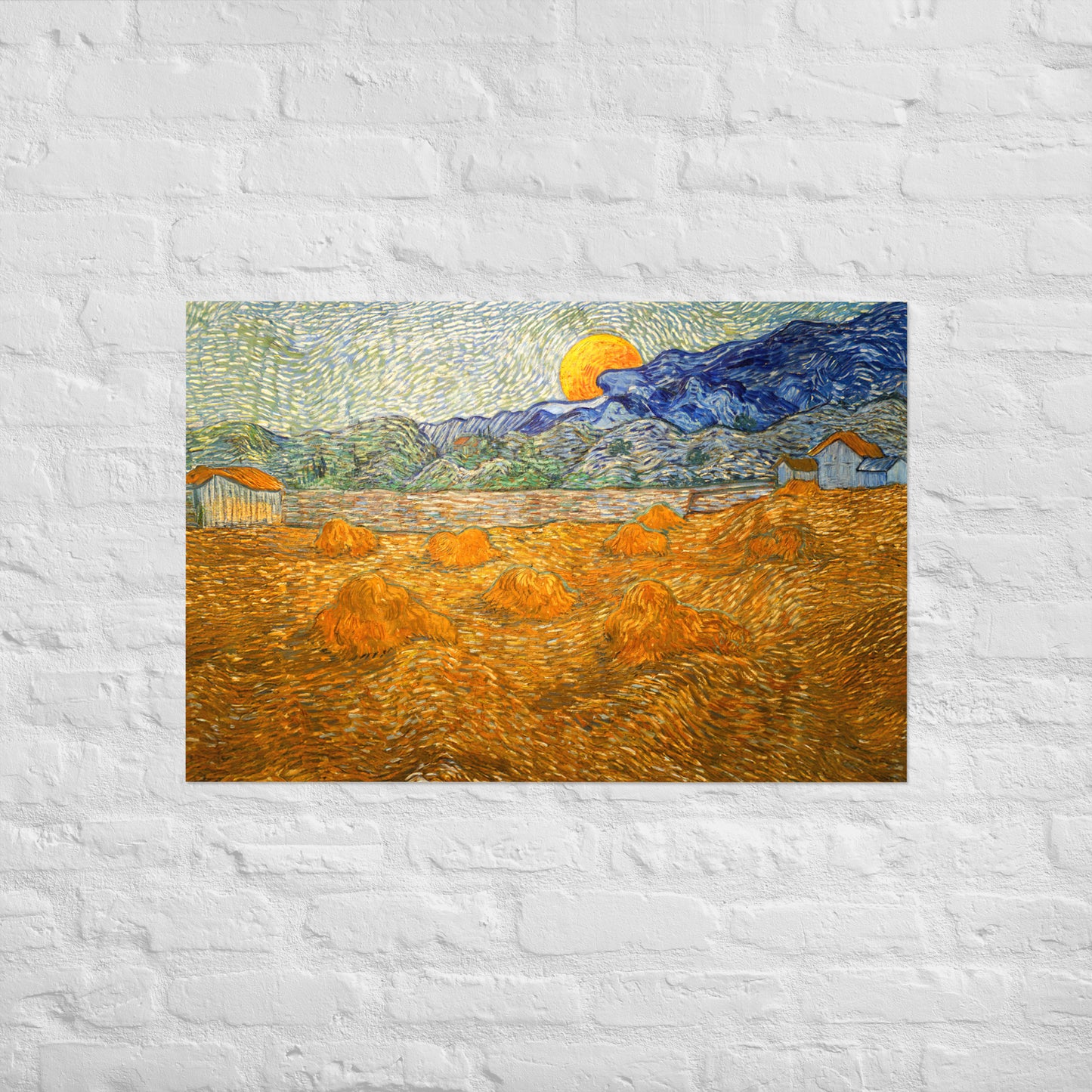 Van Gogh's 'Landscape with Wheat Sheaves and Rising Moon' on a 24"x36" unframed poster print on a white brick wall.