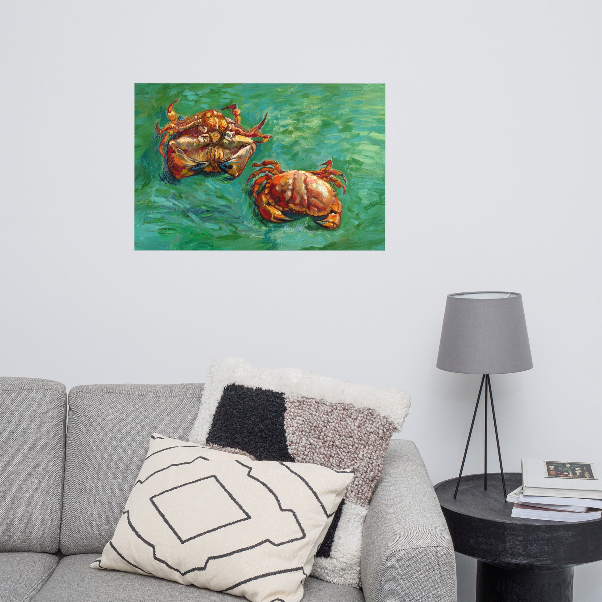 Van Gogh's 'Two Crabs' on a 24"x36" unframed poster print on a white wall above a gray sofa with throw pillows and side table with a lamp.