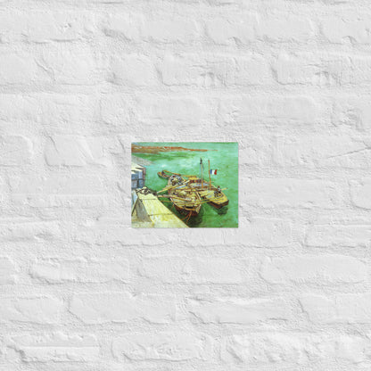 Van Gogh's 'Quay with Men Unloading Sand Barges' on a 8"x10" unframed poster print on a white brick wall.