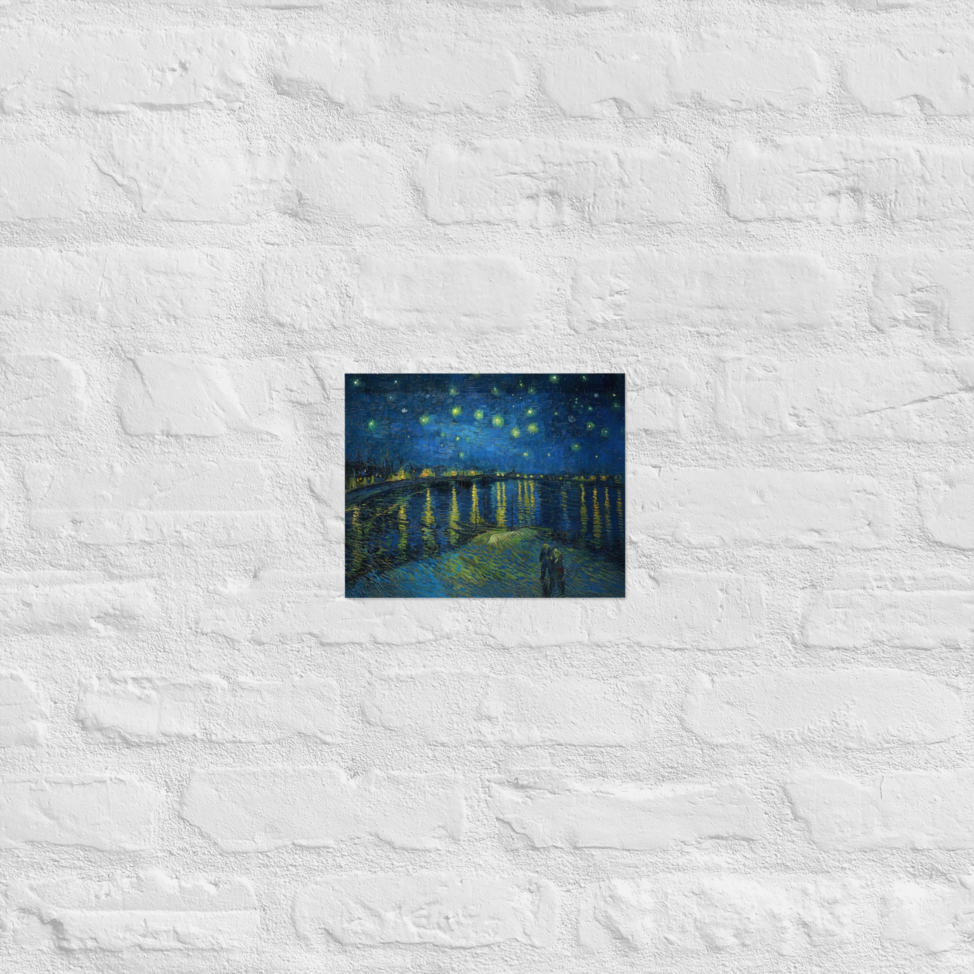 Van Gogh's 'Starry Night Over the Rhone' on a 8"x10" unframed poster print on a white brick wall.