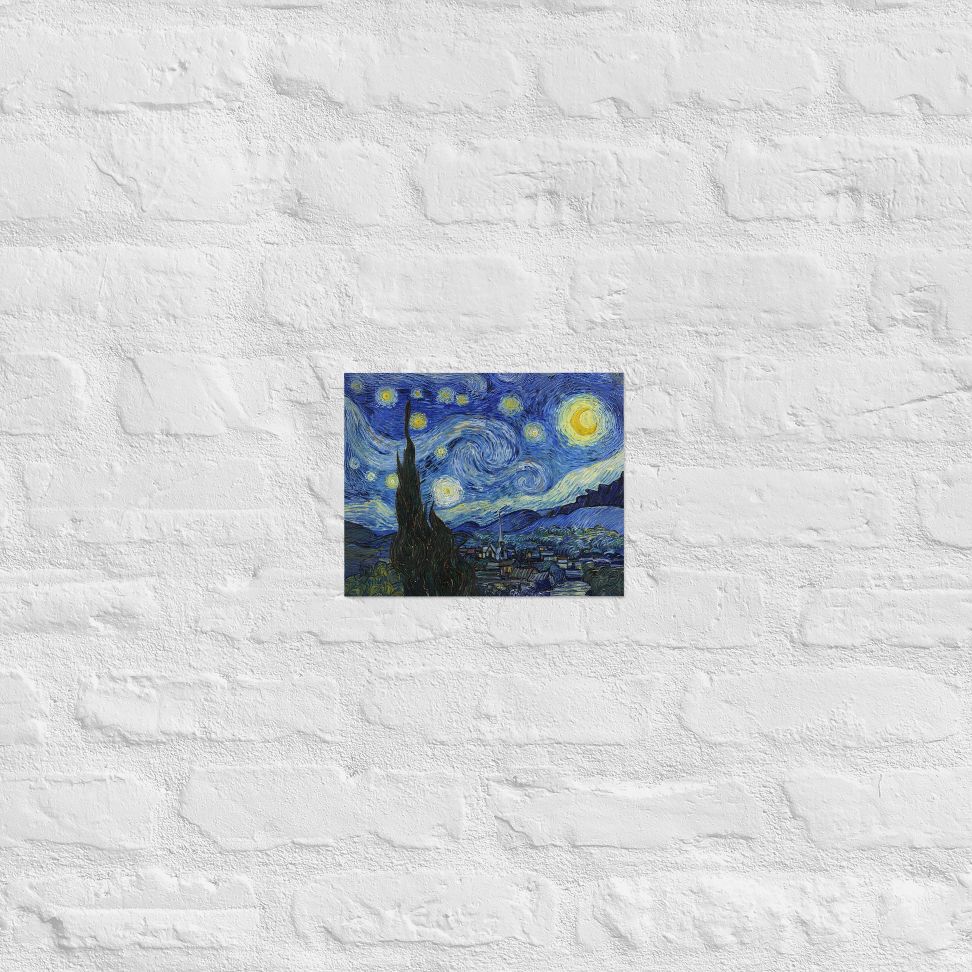 Van Gogh's 'Starry Night' on a 8"x10" unframed poster print on a white brick wall.