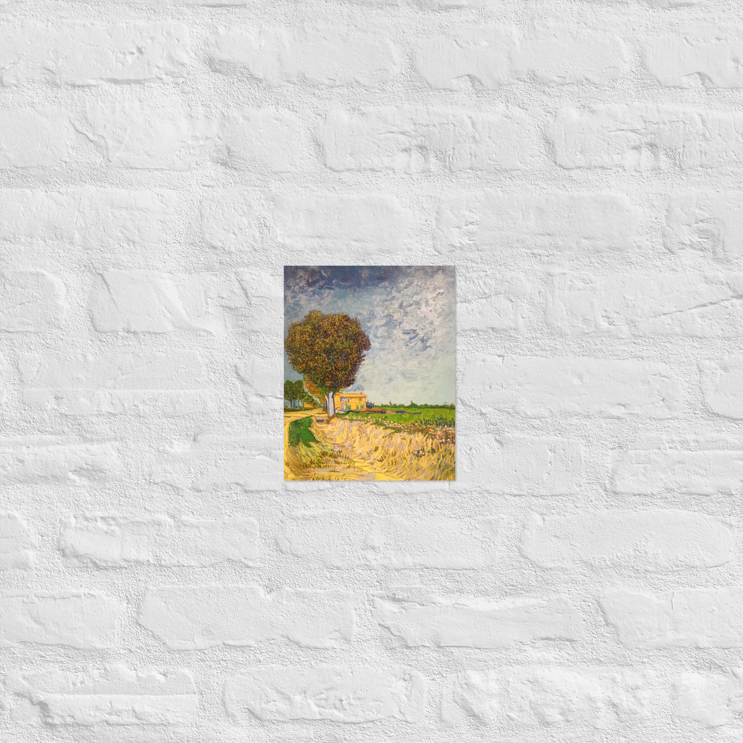 Van Gogh's 'A Lane near Arles' on a 8"x10" unframed poster print on a white brick wall.
