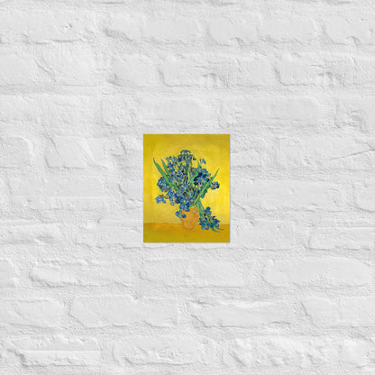 Van Gogh's 'Vase with Irises Against a Yellow Background' on a 8"x10" unframed poster print on a white brick wall.
