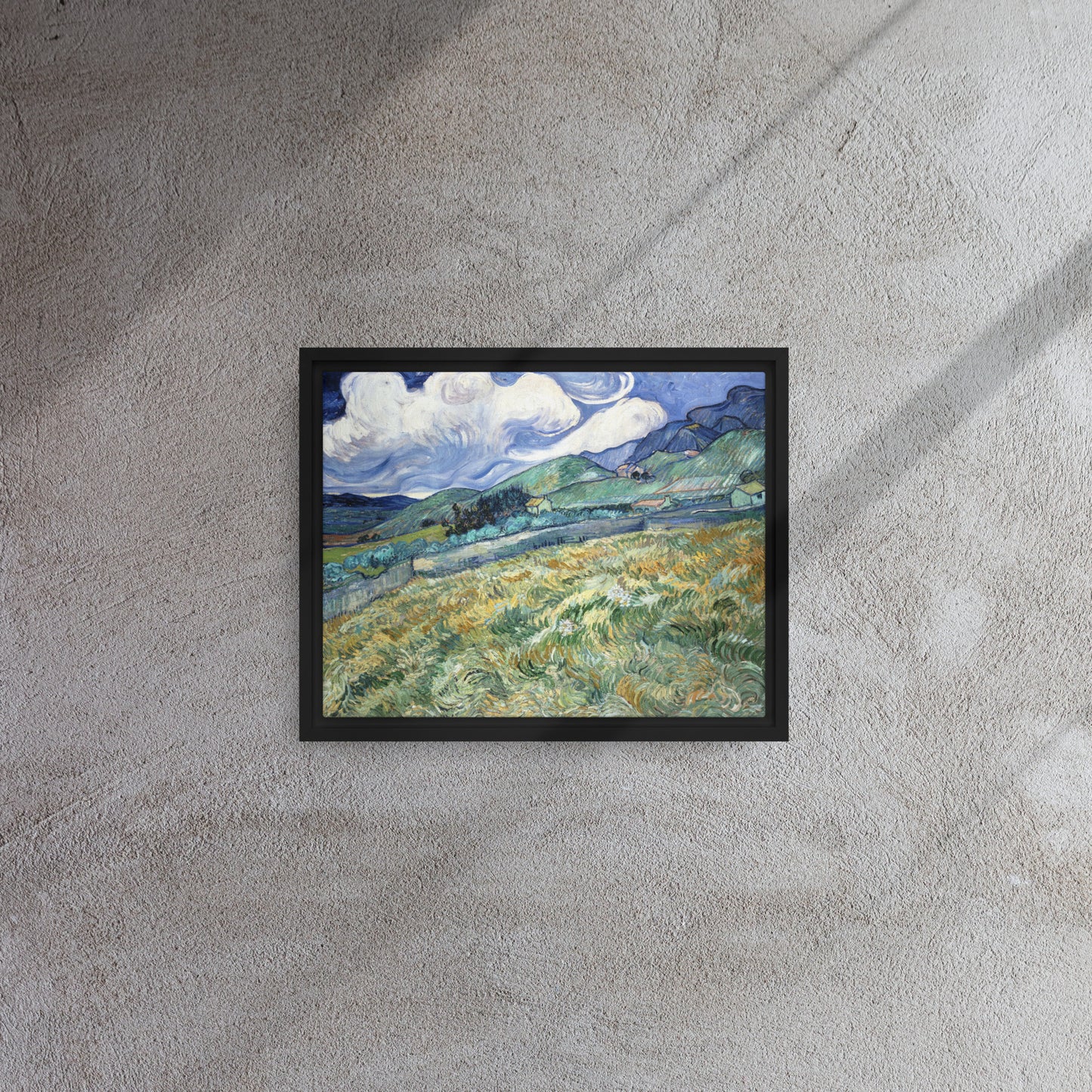 Van Gogh's 'Landscape from Saint-Rémy' on a 11"x14" black framed canvas print on a textured gray wall.