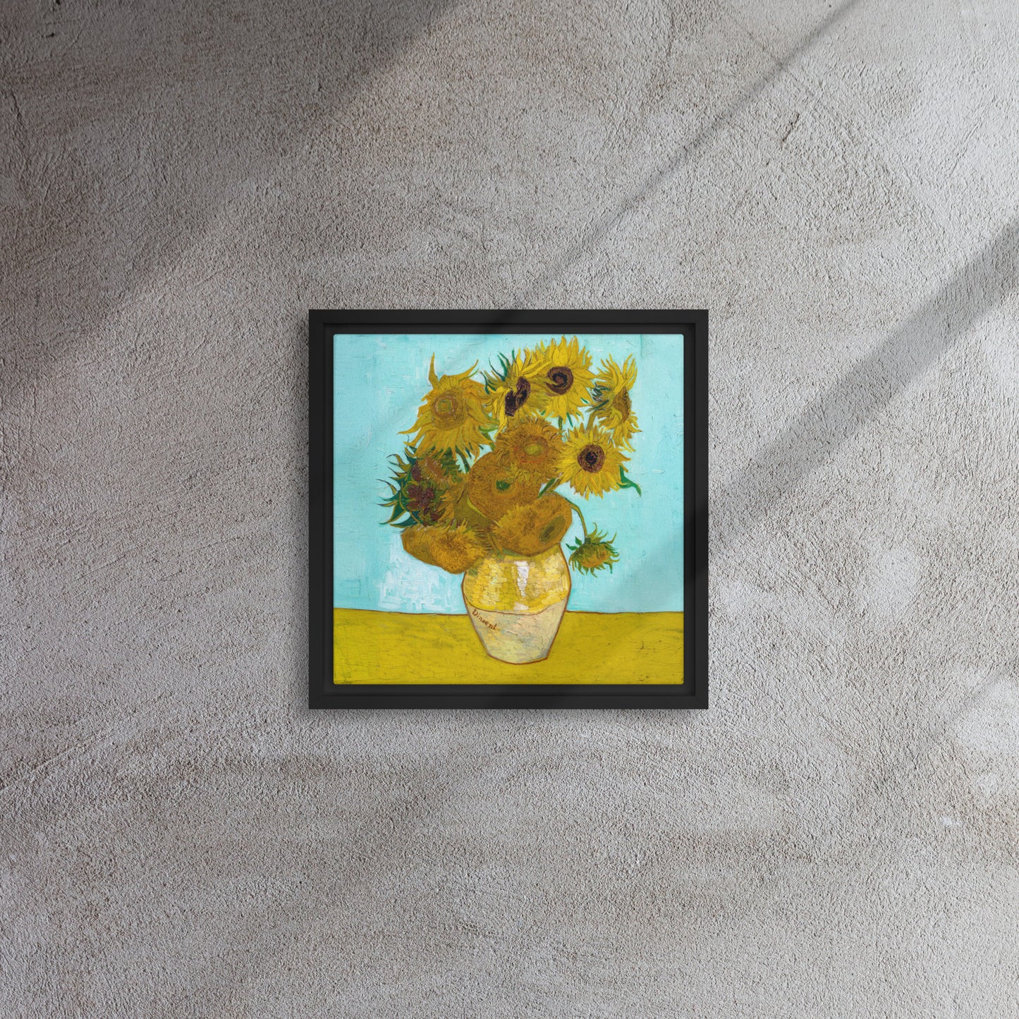 Van Gogh's 'Vase with Twelve Sunflowers' on a 12"x12" black framed canvas print on a textured gray wall.
