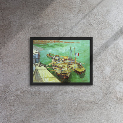 Van Gogh's 'Quay with Men Unloading Sand Barges' on a 12"x16" black framed canvas print on a textured gray wall.