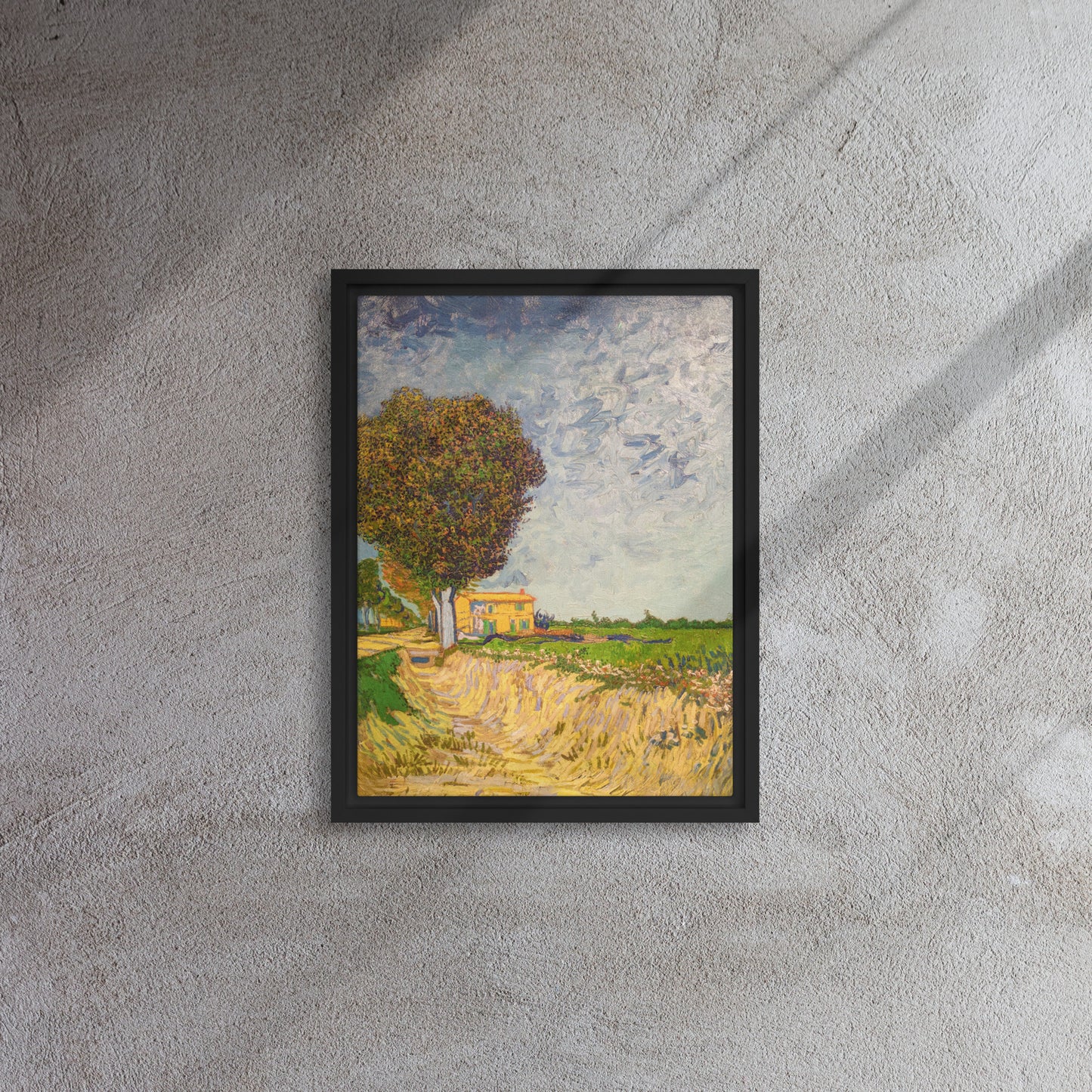 Van Gogh's 'A Lane near Arles' on a 12"x16" black framed canvas print on a textured gray wall.