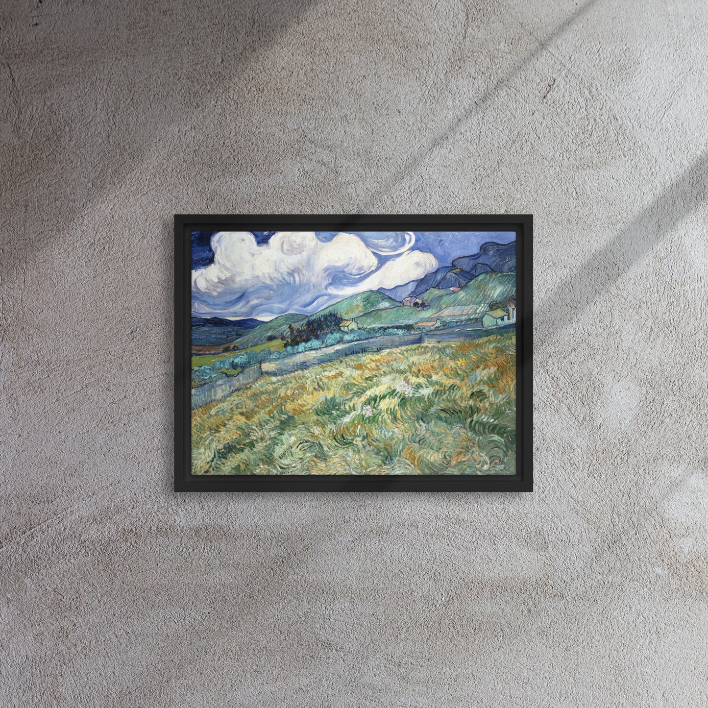 Van Gogh's 'Landscape from Saint-Rémy' on a 12"x16" black framed canvas print on a textured gray wall.