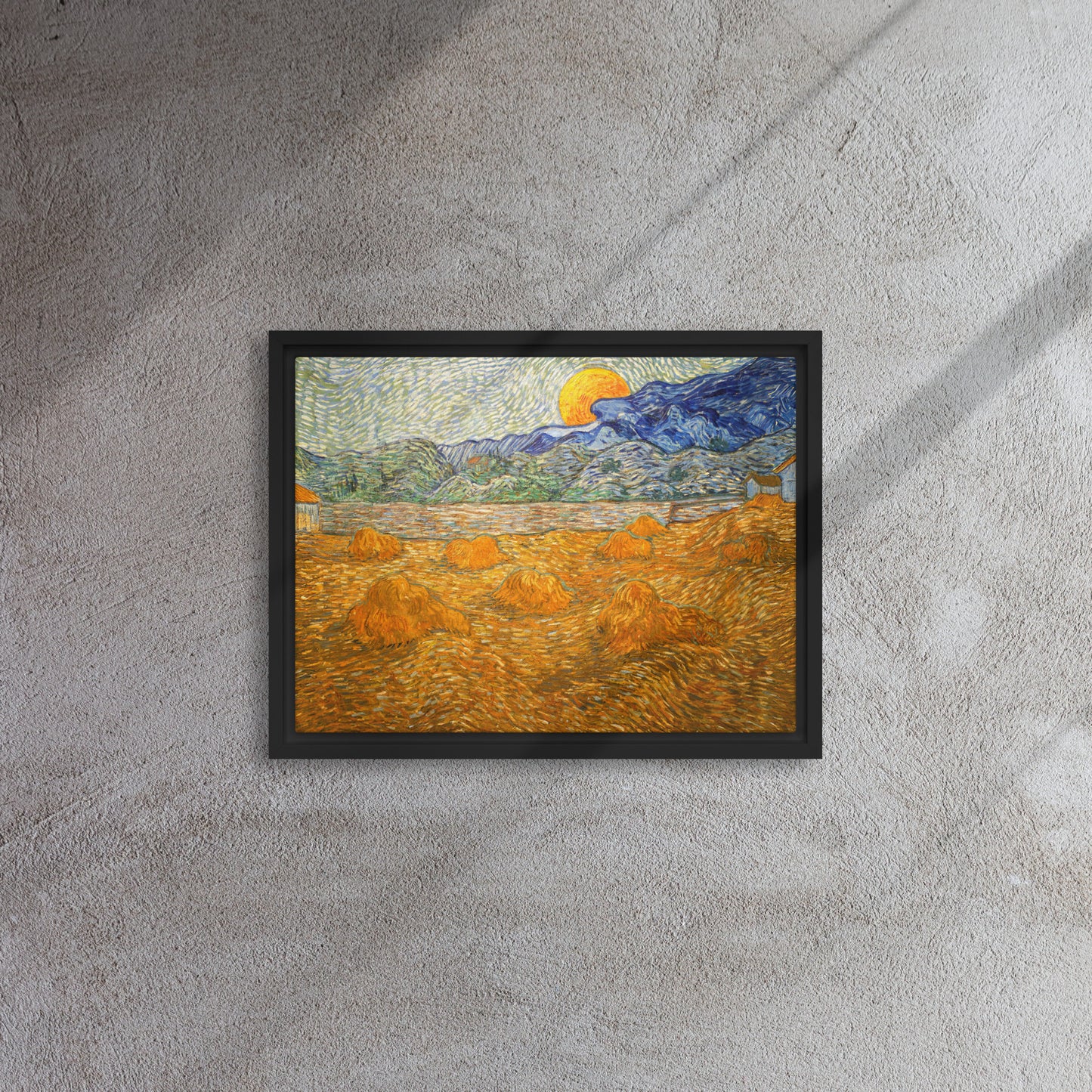 Van Gogh's 'Landscape with Wheat Sheaves and Rising Moon' on a 12"x16" black framed canvas print on a textured gray wall.