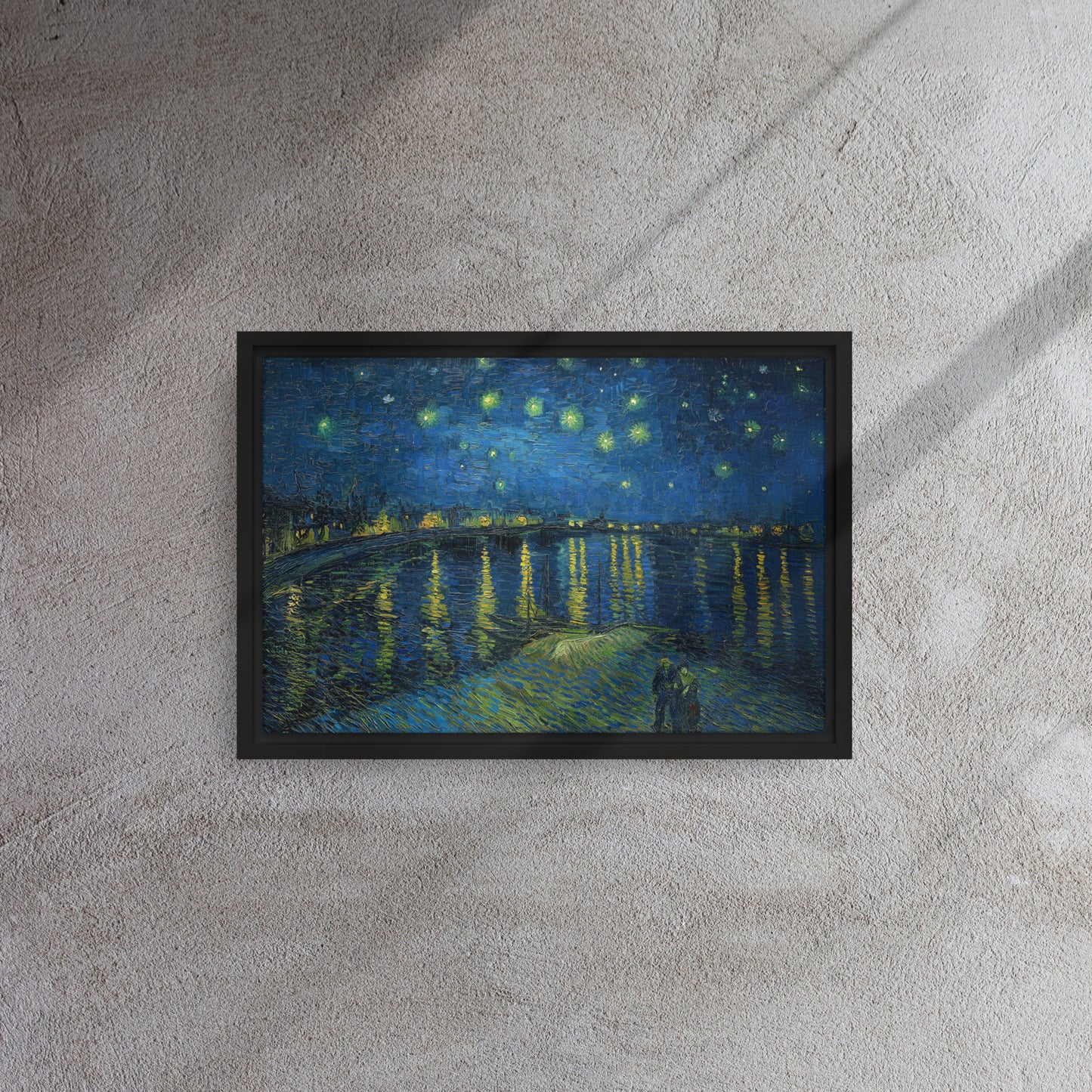 Van Gogh's 'Starry Night Over the Rhone' on a 12"x18" black framed canvas print on a textured gray wall.