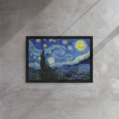 Van Gogh's 'Starry Night' on a 12"x18" black framed canvas print on a textured gray wall.