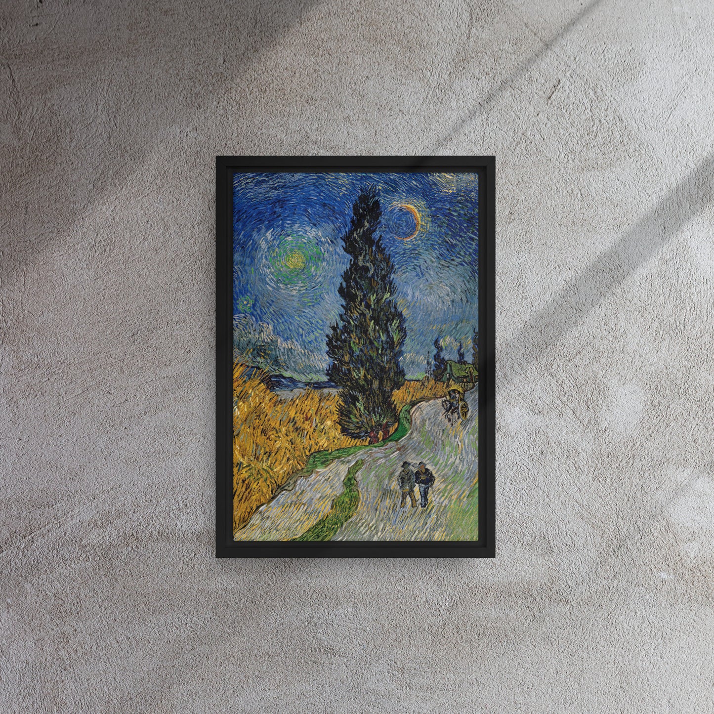 Van Gogh's 'Road with Cypress and Star' on a 12"x18" black framed canvas print on a textured gray wall.