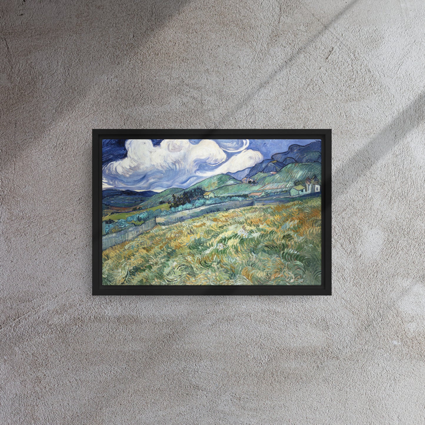 Van Gogh's 'Landscape from Saint-Rémy' on a 12"x18" black framed canvas print on a textured gray wall.