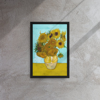 Van Gogh's 'Vase with Twelve Sunflowers' on a 12"x18" black framed canvas print on a textured gray wall.