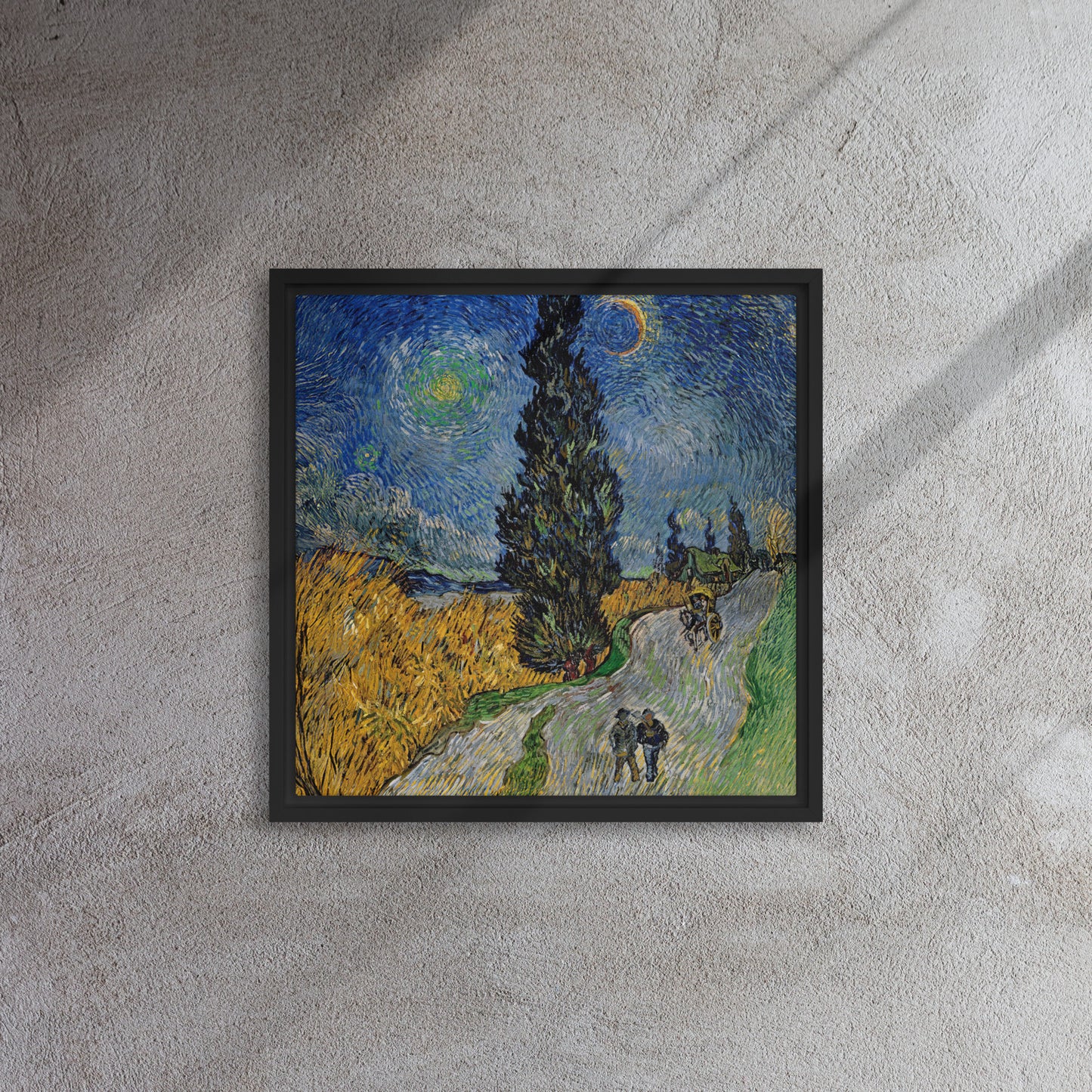 Van Gogh's 'Road with Cypress and Star' on a 16"x16" black framed canvas print on a textured gray wall.