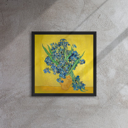 Van Gogh's 'Vase with Irises Against a Yellow Background' on a 16"x16" black framed canvas print on a textured gray wall.